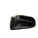Charger l&#39;image dans la galerie, Black leather handbag with gold hardware on a white background
