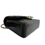 Charger l&#39;image dans la galerie, Black quilted handbag with gold hardware on a white background
