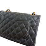 Charger l&#39;image dans la galerie, Black quilted handbag with gold hardware on a white background
