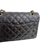 Charger l&#39;image dans la galerie, Black quilted handbag with gold hardware on a white background

