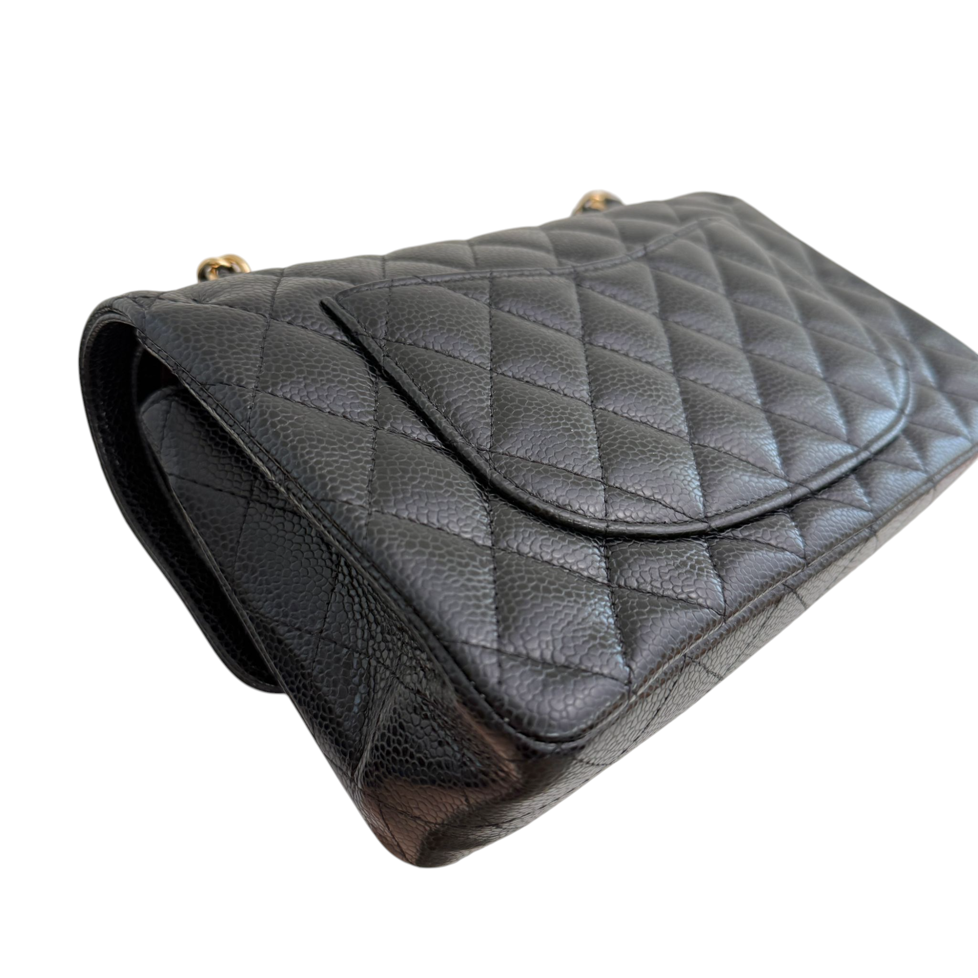 Quilted black handbag on a white background