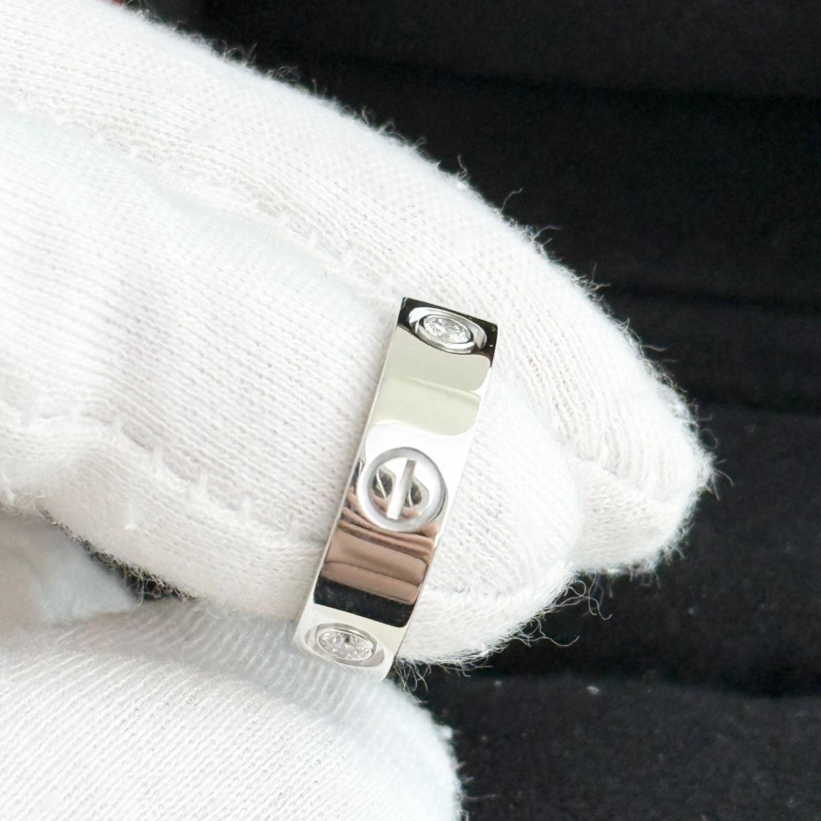 Silver ring with peace symbol on a white fabric background