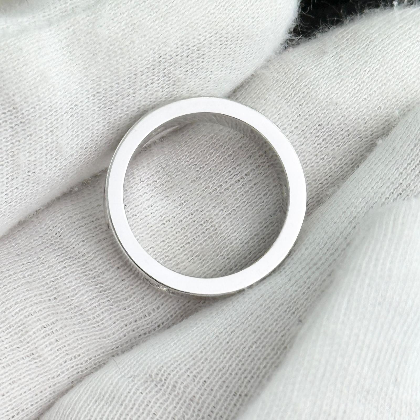 Silver ring on a textured white fabric background