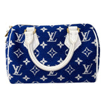 将图片加载到图库查看器，Blue handbag with white monogram pattern on a white background
