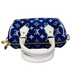 将图片加载到图库查看器，Blue handbag with white monogram pattern and gold accents on a white background

