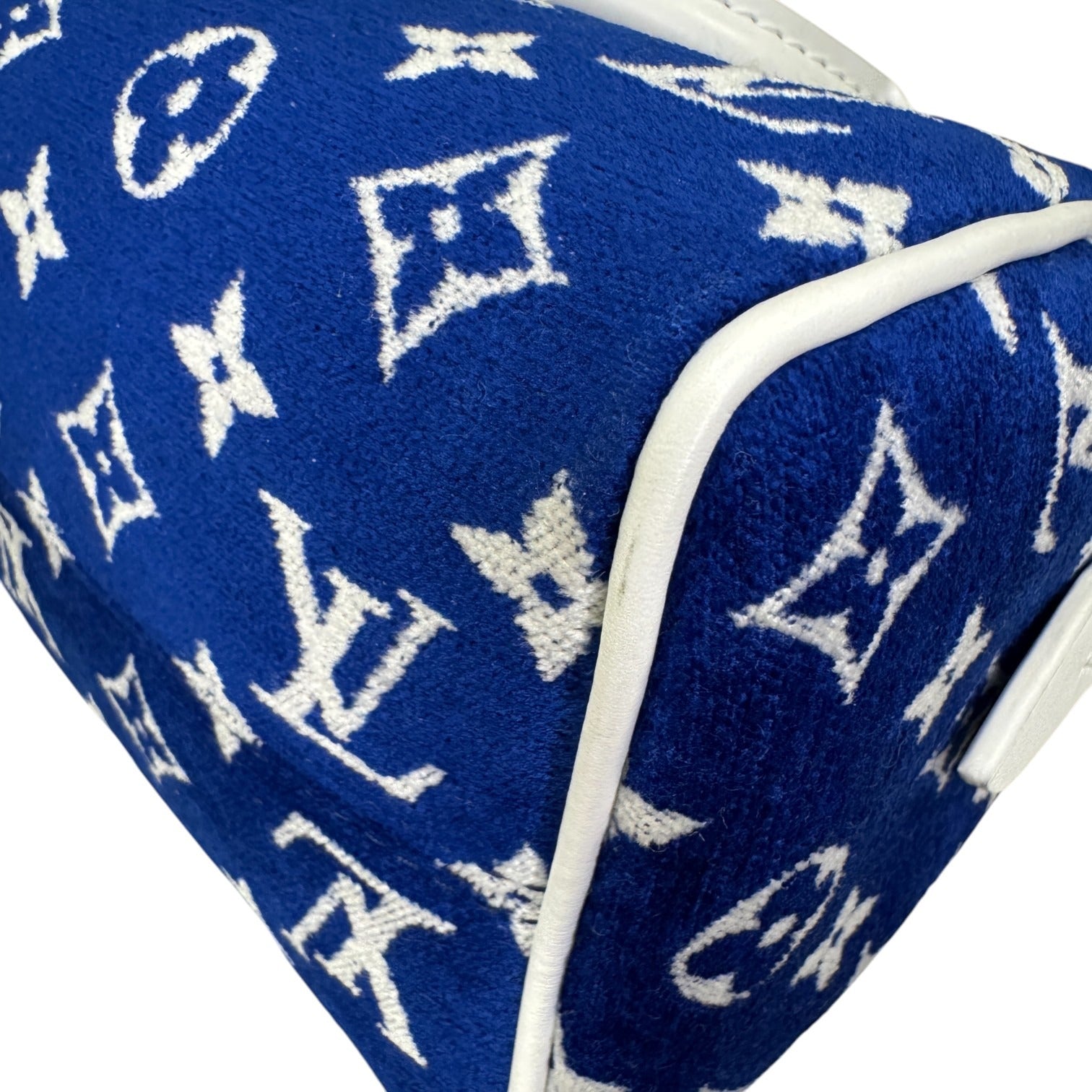 Blue fabric with white logo pattern on a white background