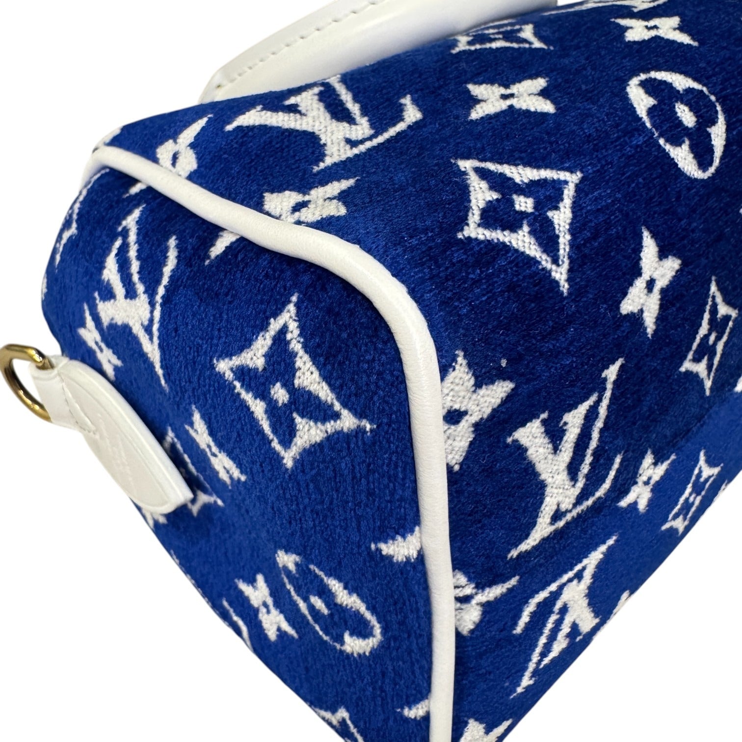 Blue pouch with white monogram pattern on a white background