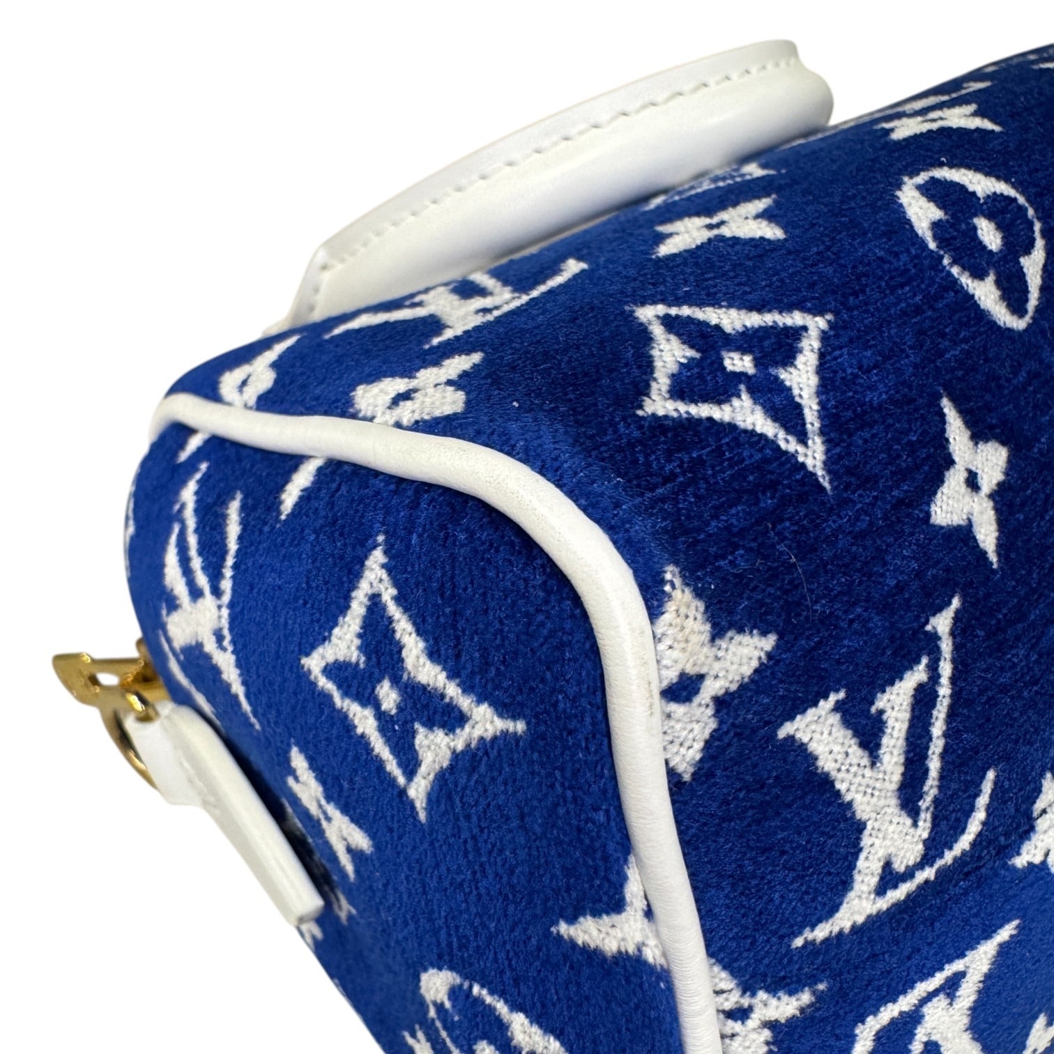 Blue pouch with white monogram pattern on a white background