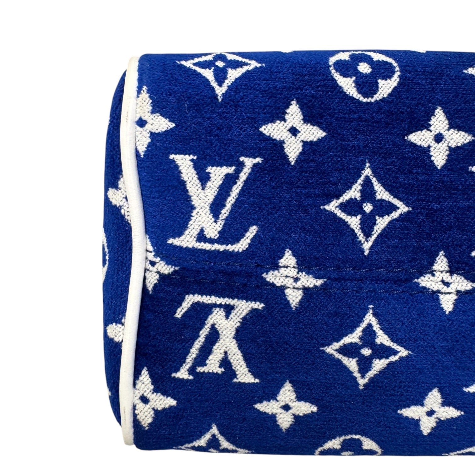 Blue blanket with white Louis Vuitton monogram pattern on a white background