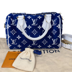 将图片加载到图库查看器，Blue handbag with white monogram pattern on a beige surface with Louis Vuitton packaging.

