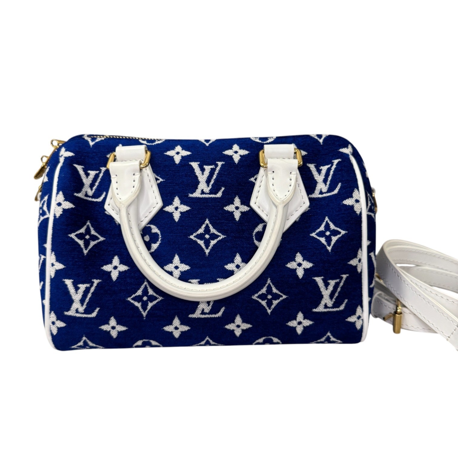 Blue handbag with white monogram pattern on a white background