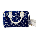 将图片加载到图库查看器，Blue handbag with white monogram pattern on a white background

