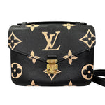 Charger l&#39;image dans la galerie, Black handbag with gold monogram pattern on a white background
