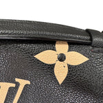 Charger l&#39;image dans la galerie, Close-up of a black leather handbag with gold flower detail and brand logo.
