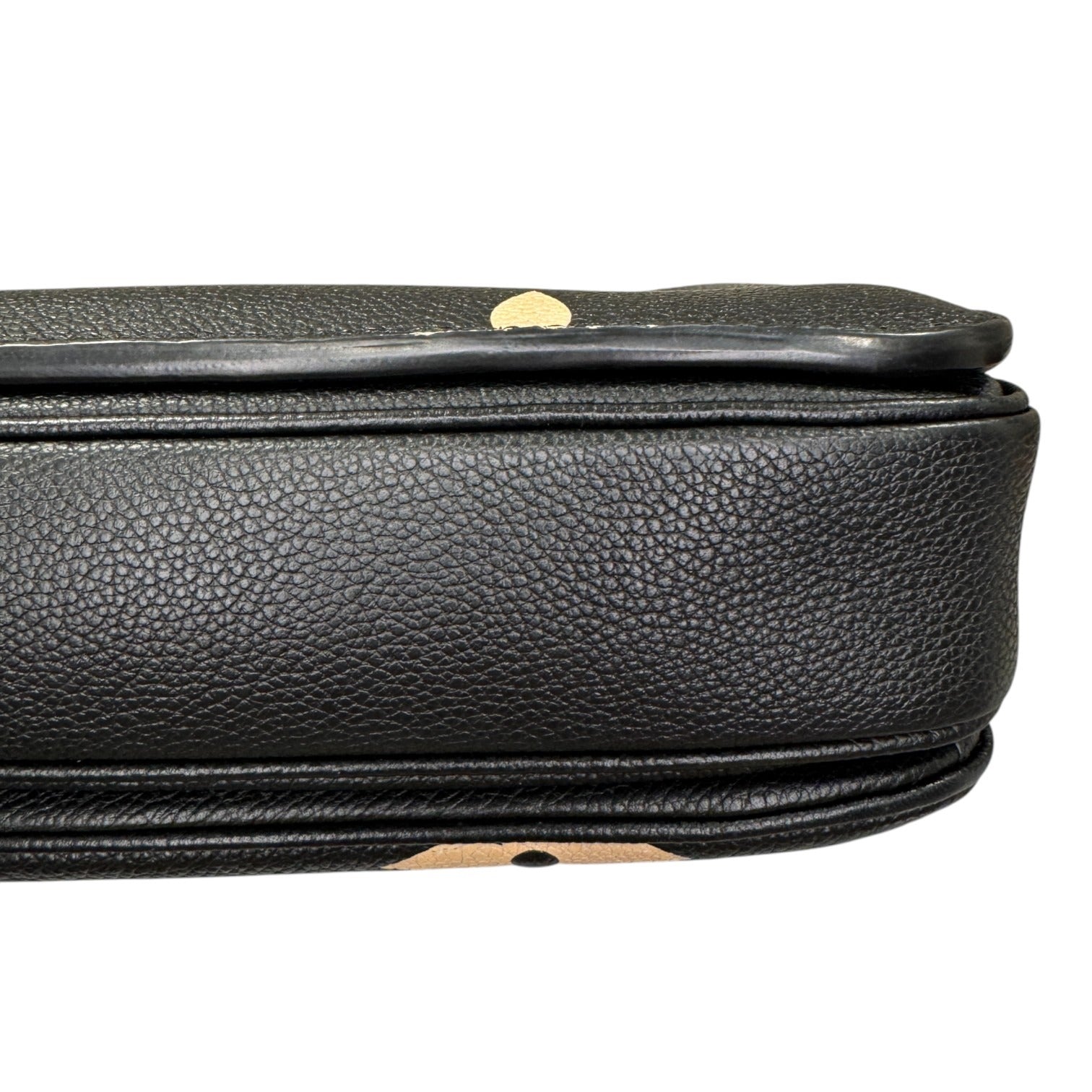 Close-up of a black leather suitcase handle on a white background