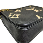 Charger l&#39;image dans la galerie, Black leather bag with gold floral patterns on a white background
