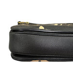 Charger l&#39;image dans la galerie, Close-up of a black leather handbag with gold accents on a white background
