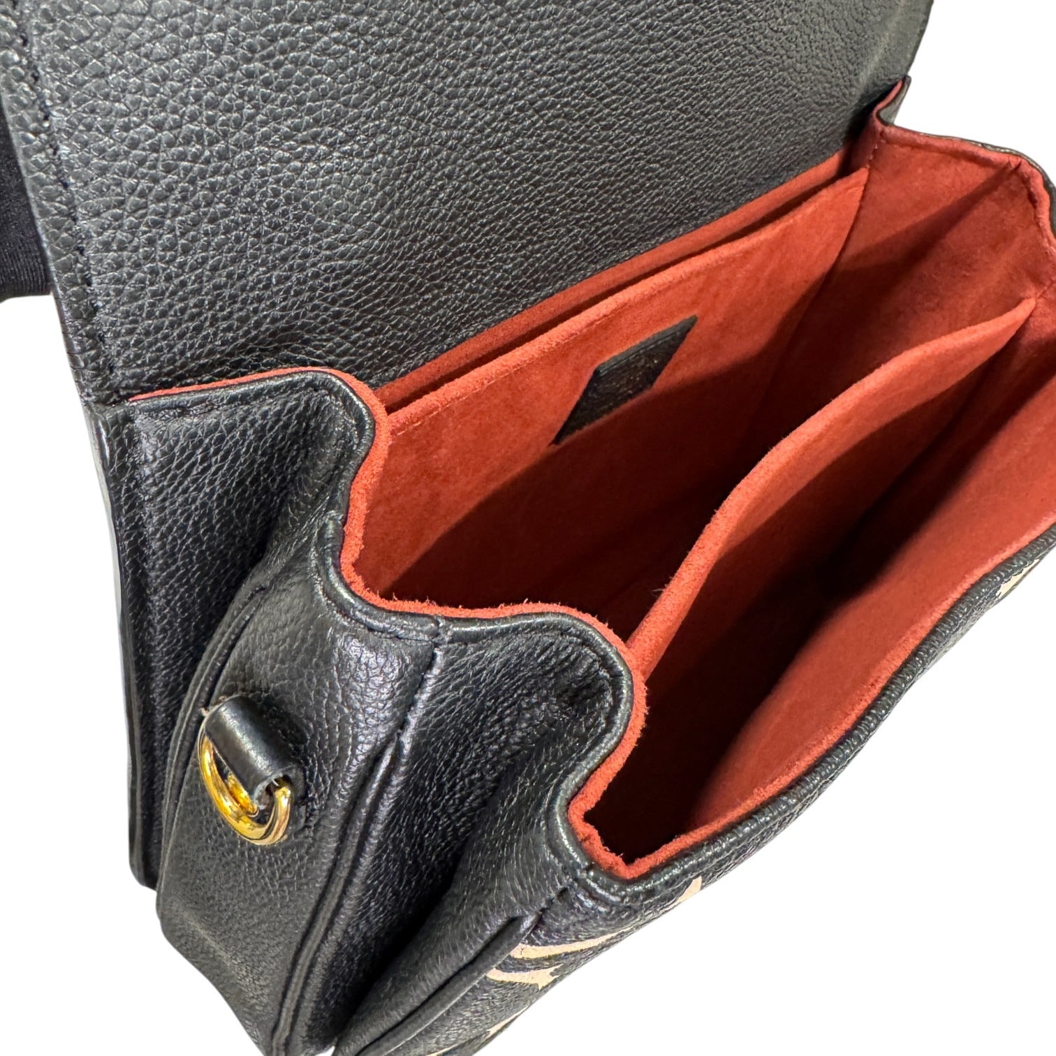 Black leather bag with red interior and gold clasp on a white background