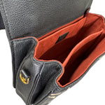 Charger l&#39;image dans la galerie, Black leather bag with red interior and gold clasp on a white background
