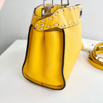 将图片加载到图库查看器，Yellow leather handbag with perforated top handle on a white surface
