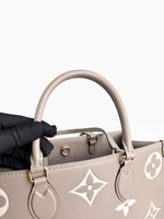Load image into Gallery viewer, Louis Vuitton LV OnTheGo MM Tote Empreinte Leather Beige/Cream

