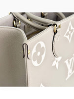 Load image into Gallery viewer, Louis Vuitton LV OnTheGo MM Tote Empreinte Leather Beige/Cream
