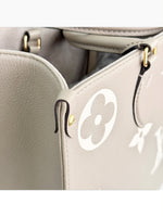 Load image into Gallery viewer, Louis Vuitton LV OnTheGo MM Tote Empreinte Leather Beige/Cream
