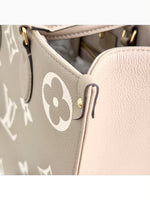 Load image into Gallery viewer, Louis Vuitton LV OnTheGo MM Tote Empreinte Leather Beige/Cream
