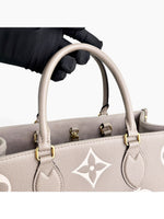 Load image into Gallery viewer, Louis Vuitton LV OnTheGo MM Tote Empreinte Leather Beige/Cream

