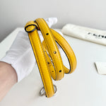 将图片加载到图库查看器，Yellow leather belt on a stand with a white background
