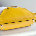将图片加载到图库查看器，Yellow handbag with silver studs on a light gray background
