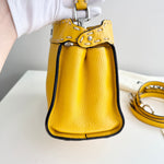 将图片加载到图库查看器，Yellow leather handbag with a strap on a light background
