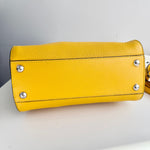 将图片加载到图库查看器，Yellow leather handbag with silver studs on a light gray background
