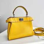 将图片加载到图库查看器，Yellow handbag with studded detail on a white surface
