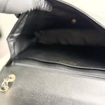 将图片加载到图库查看器，Close-up of a silver handbag with visible brand name, blurred background
