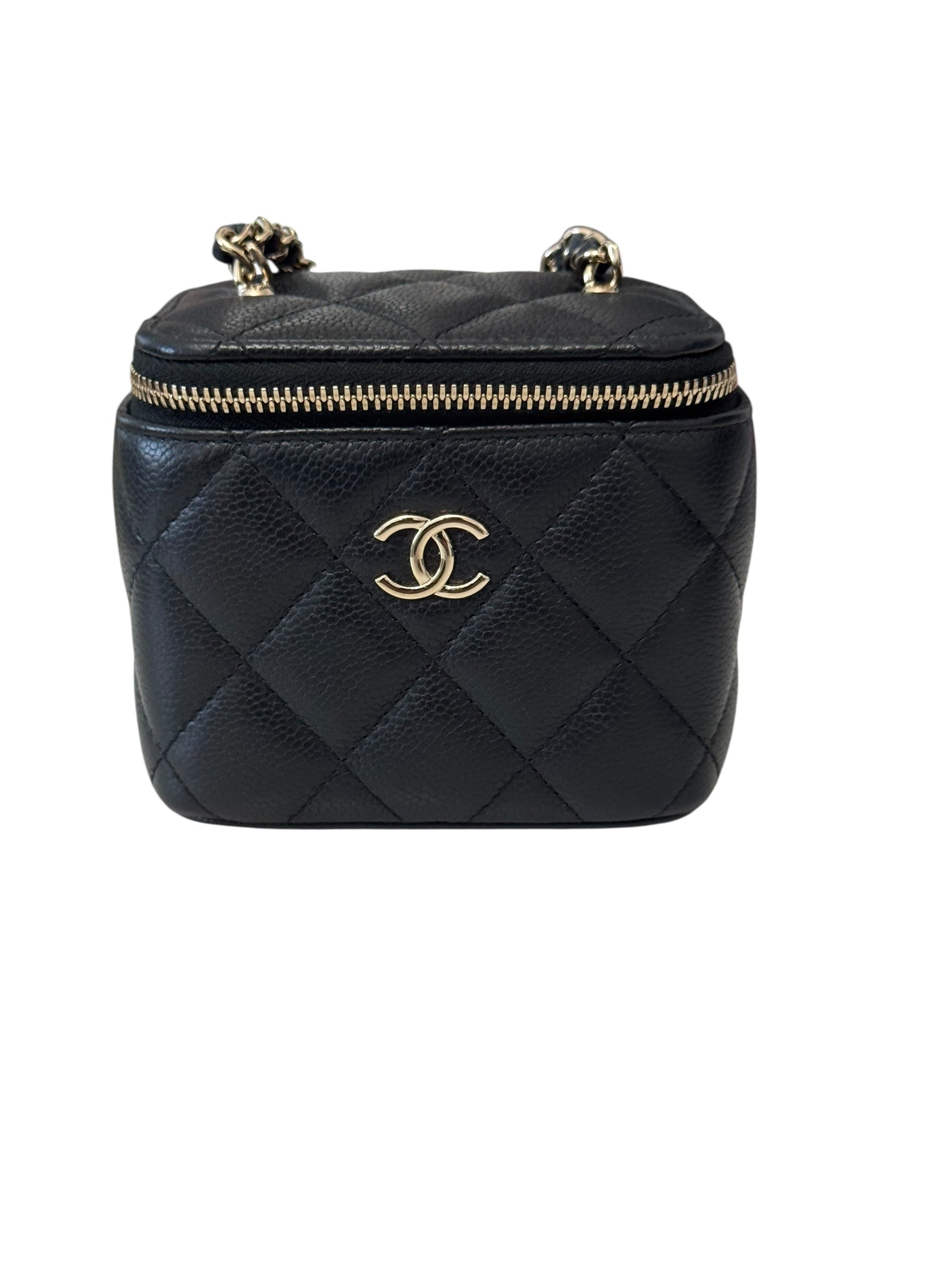Black quilted handbag with gold zipper and logo on a white background