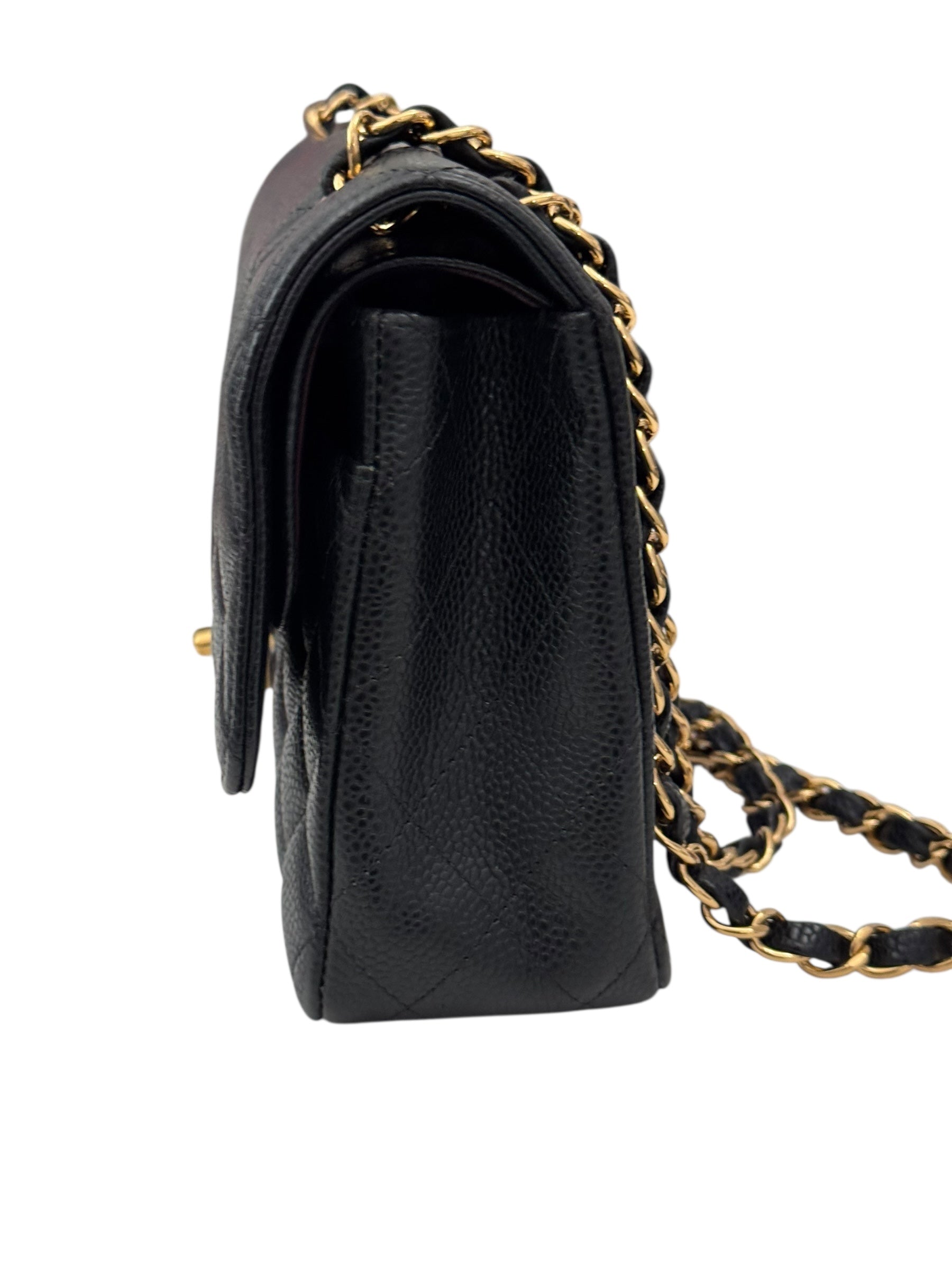 Black leather handbag with gold chain strap on a white background