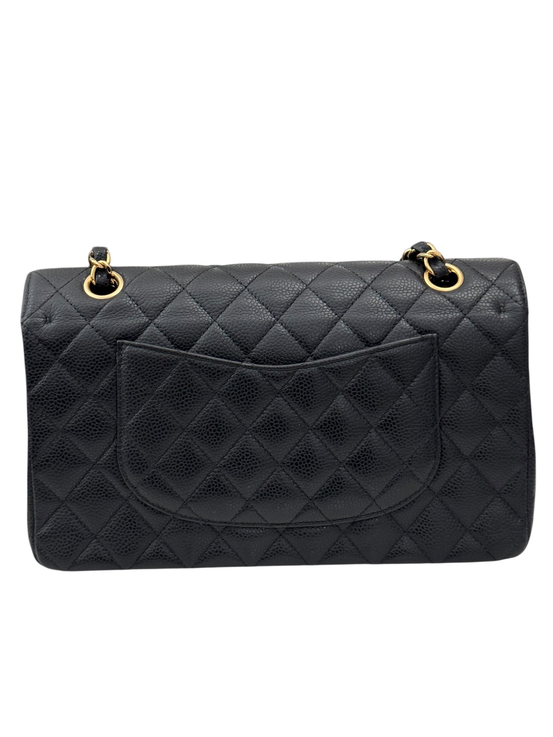 Black quilted handbag with gold hardware on a white background