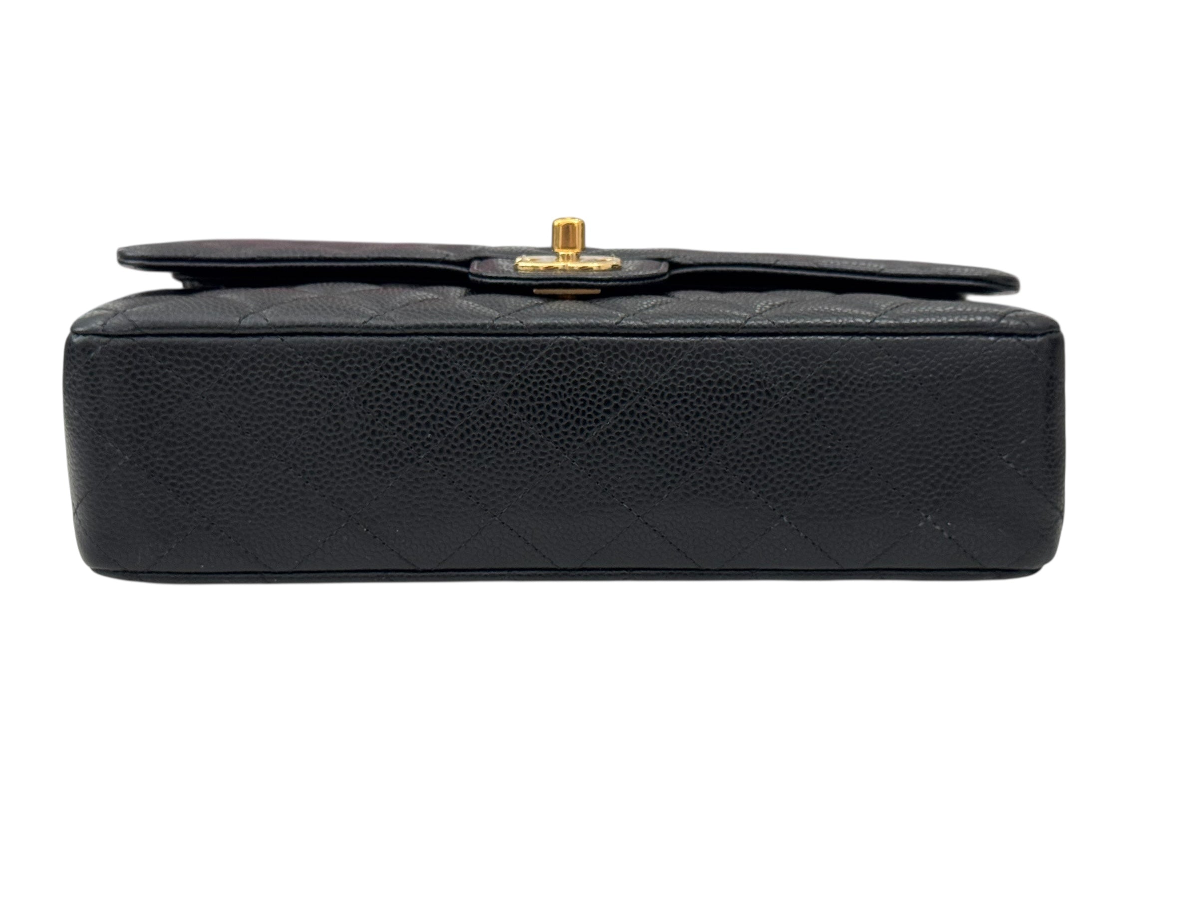 Black quilted handbag with gold clasp on a white background