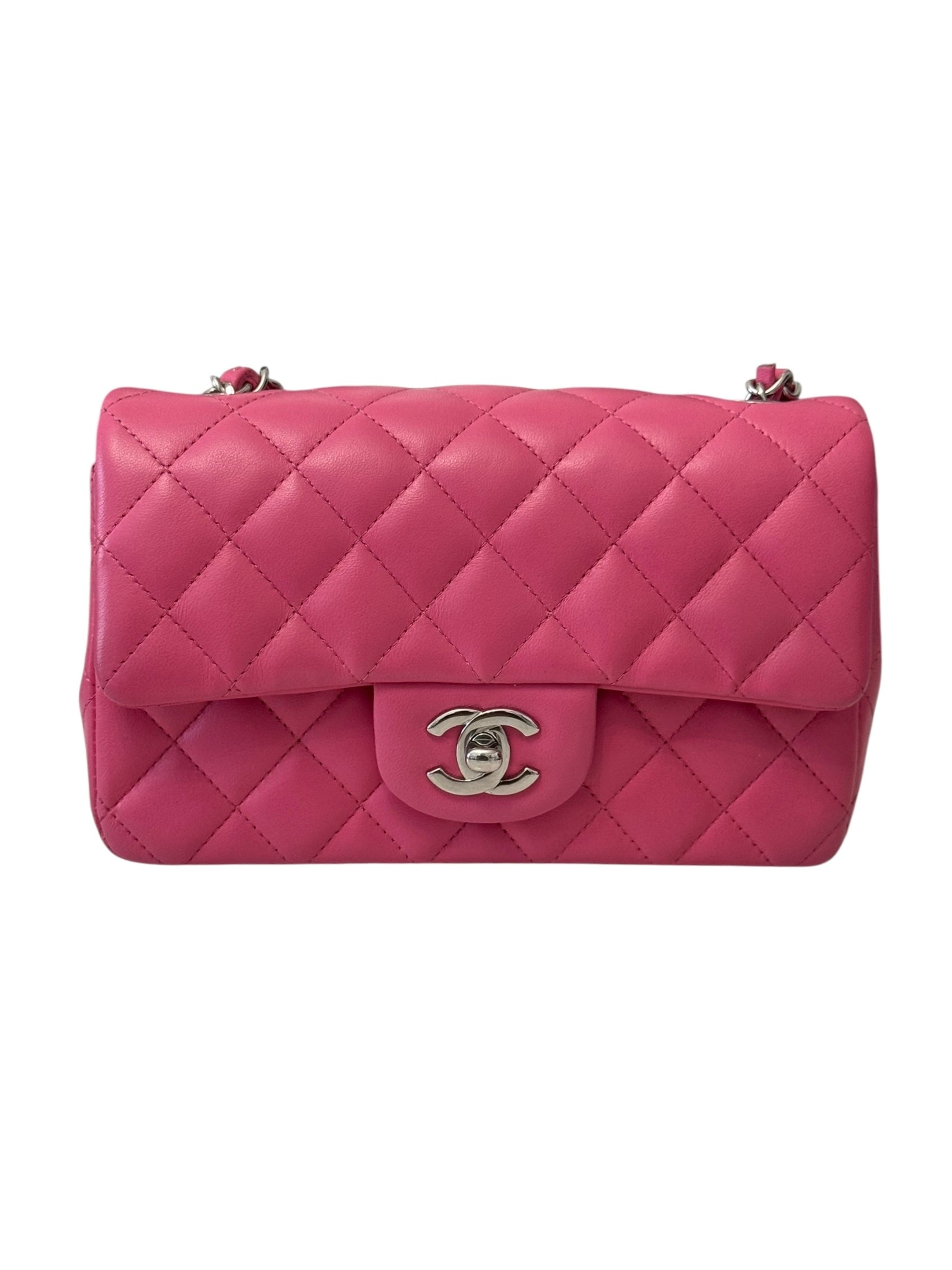 Pink quilted handbag with Chanel logo on a white background