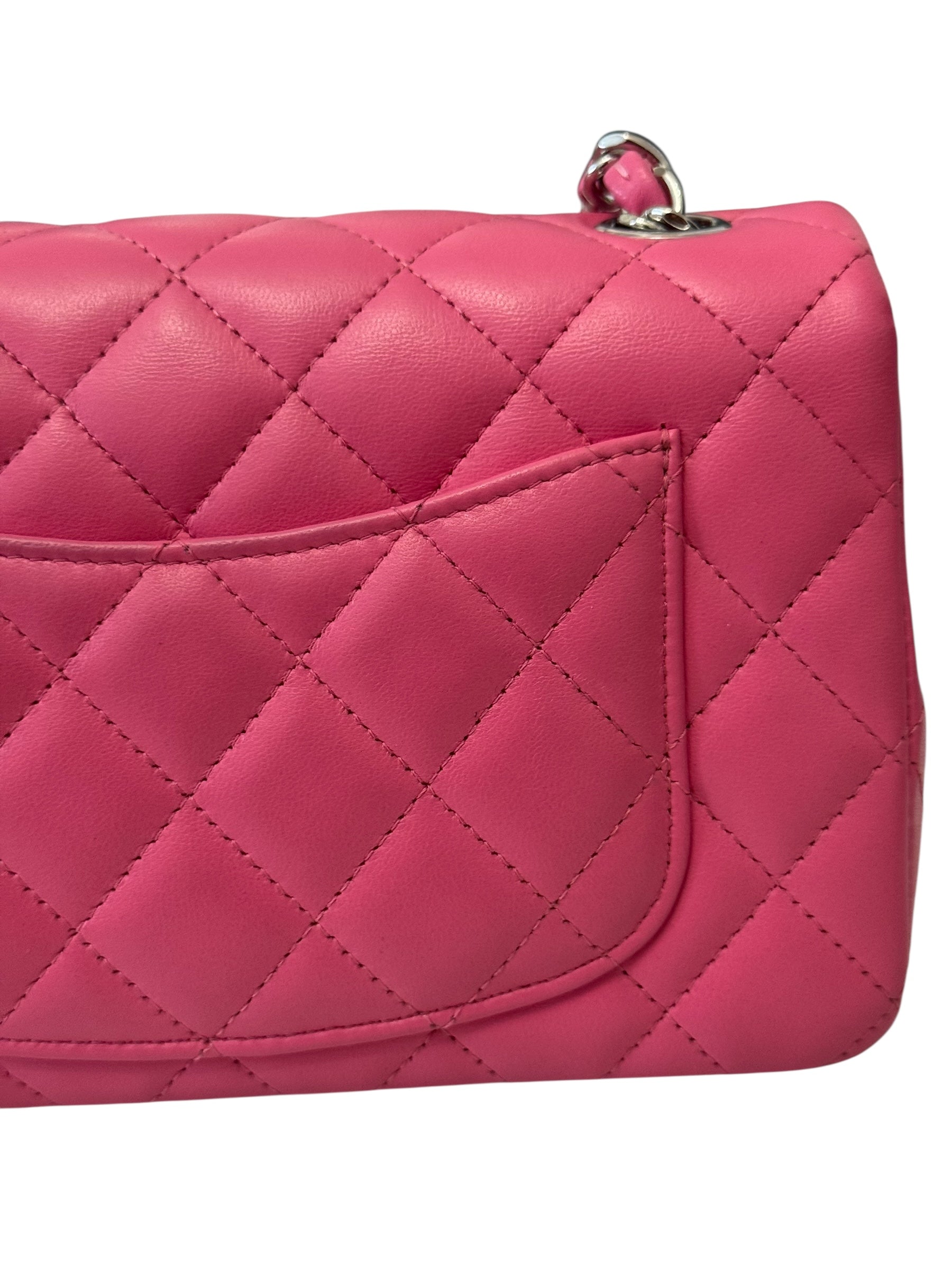Pink quilted handbag on a white background