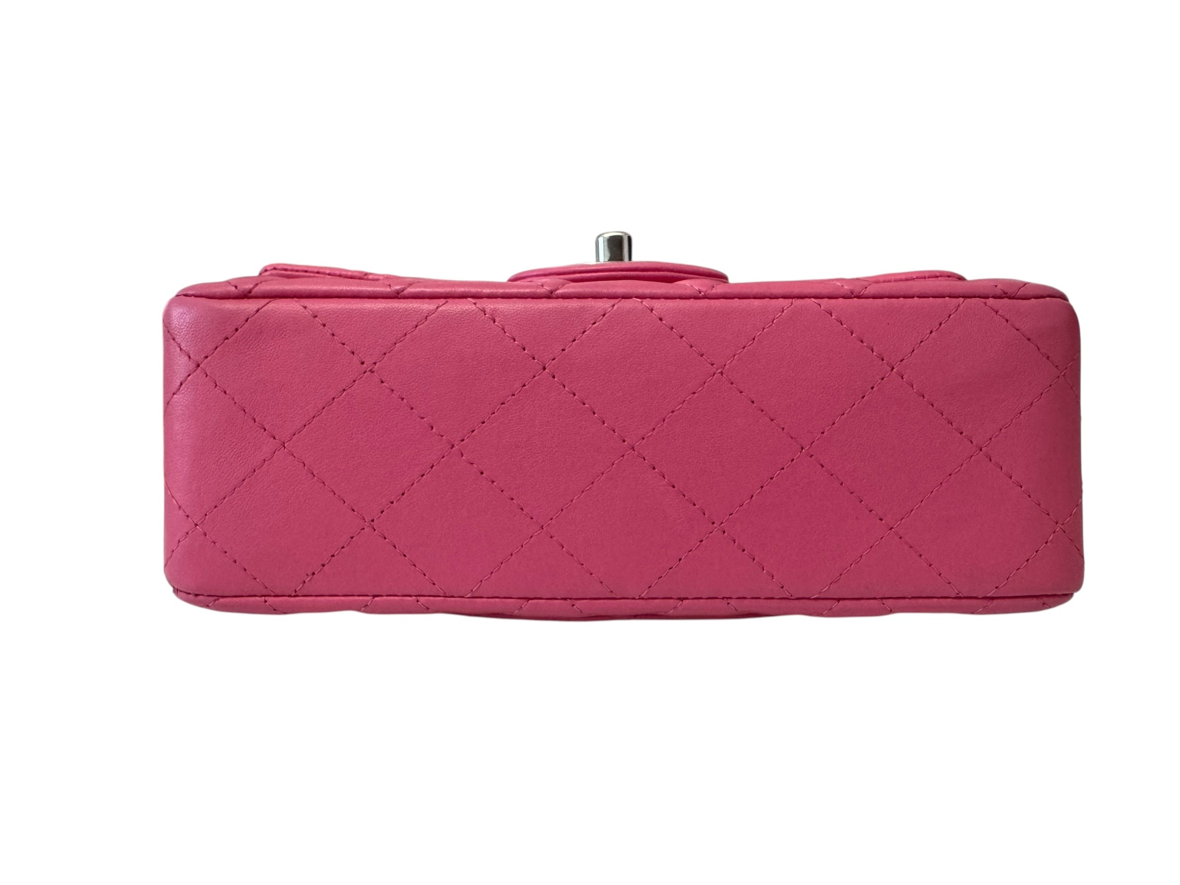 Pink quilted handbag on a white background