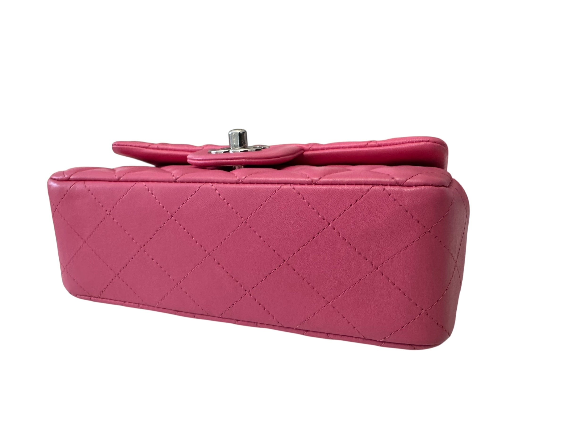Pink quilted handbag on a white background