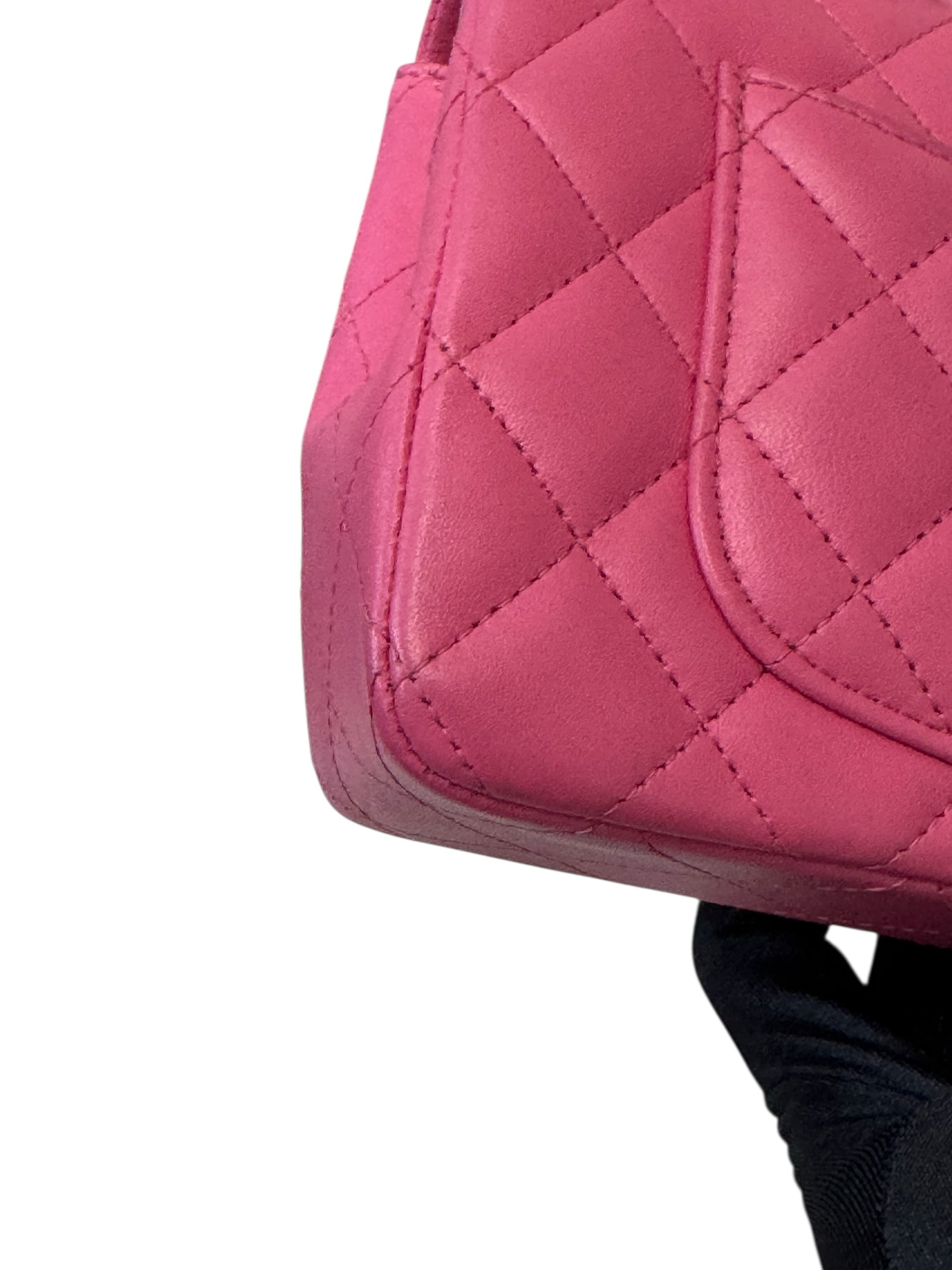 Close-up of a pink quilted handbag on a white background