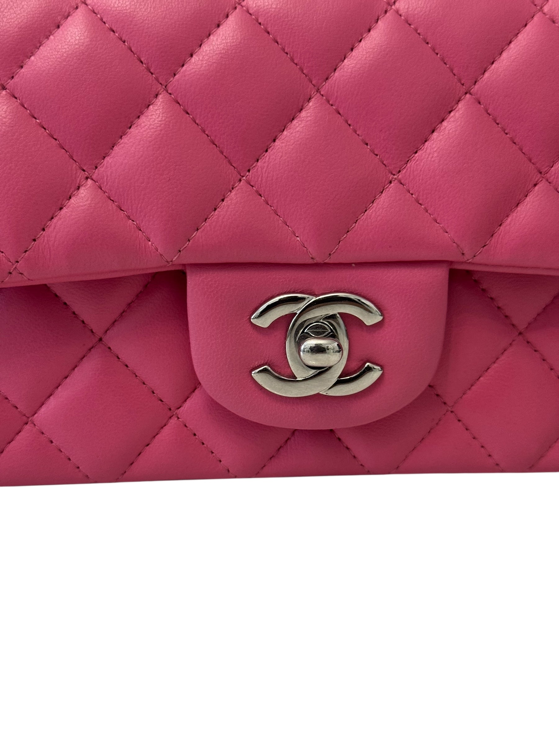 Pink quilted handbag with Chanel logo on a white background