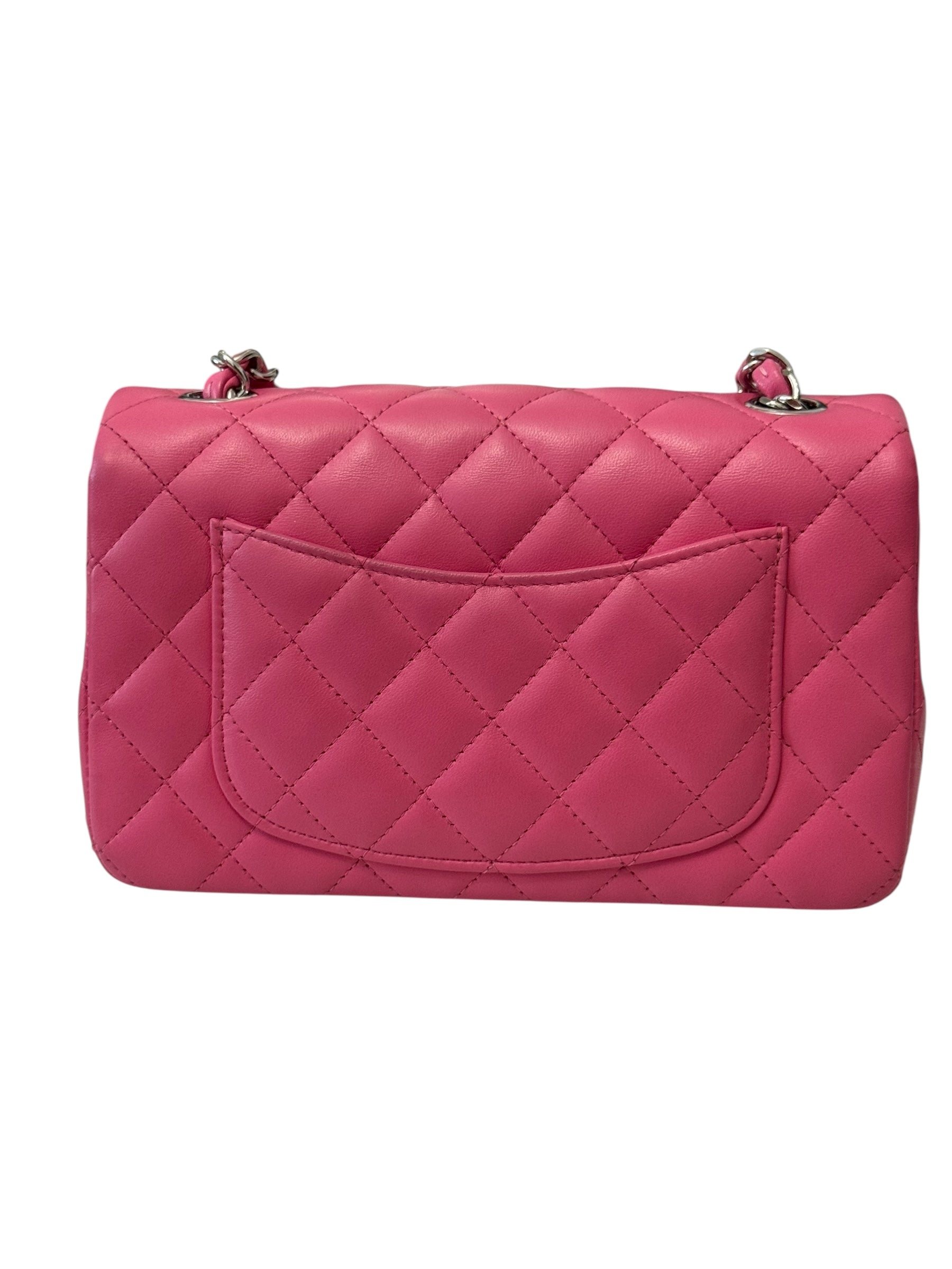 Pink quilted handbag on a white background