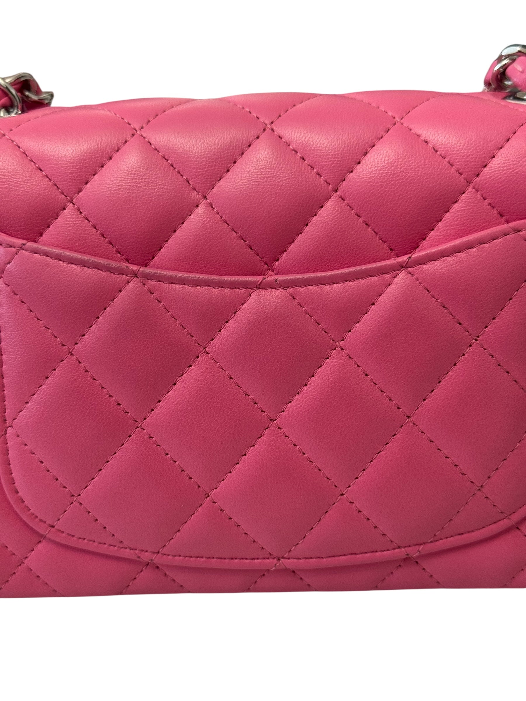 Pink quilted handbag on a white background