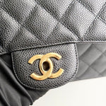 将图片加载到图库查看器，Close-up of a Chanel handbag with gold logo on a white background
