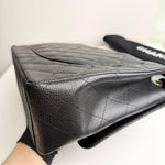 将图片加载到图库查看器，Black quilted handbag with visible brand name on a white background
