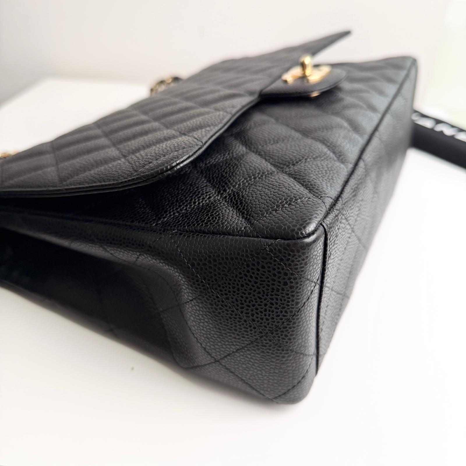 Black quilted handbag on a white background